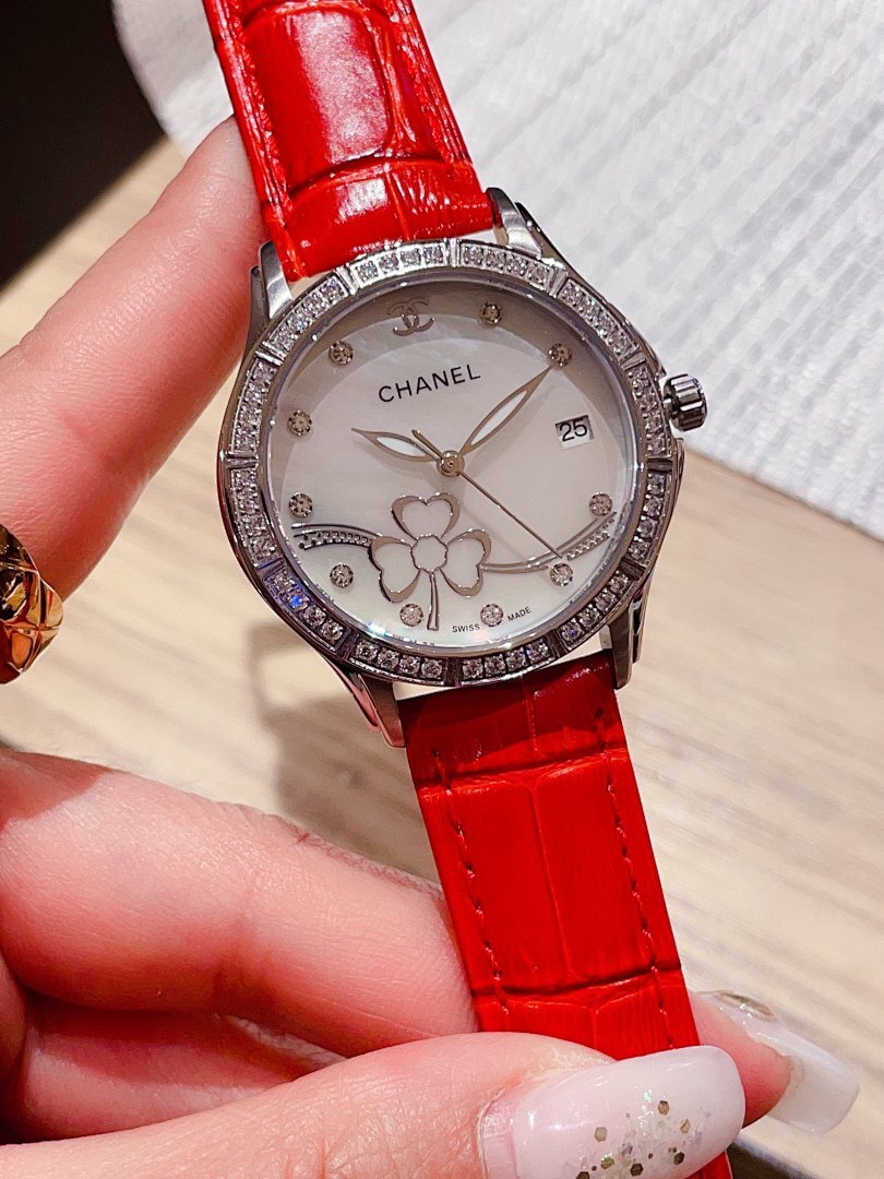 Chanel watch with red leather strap, white dial, diamond bezel, and flower motifs