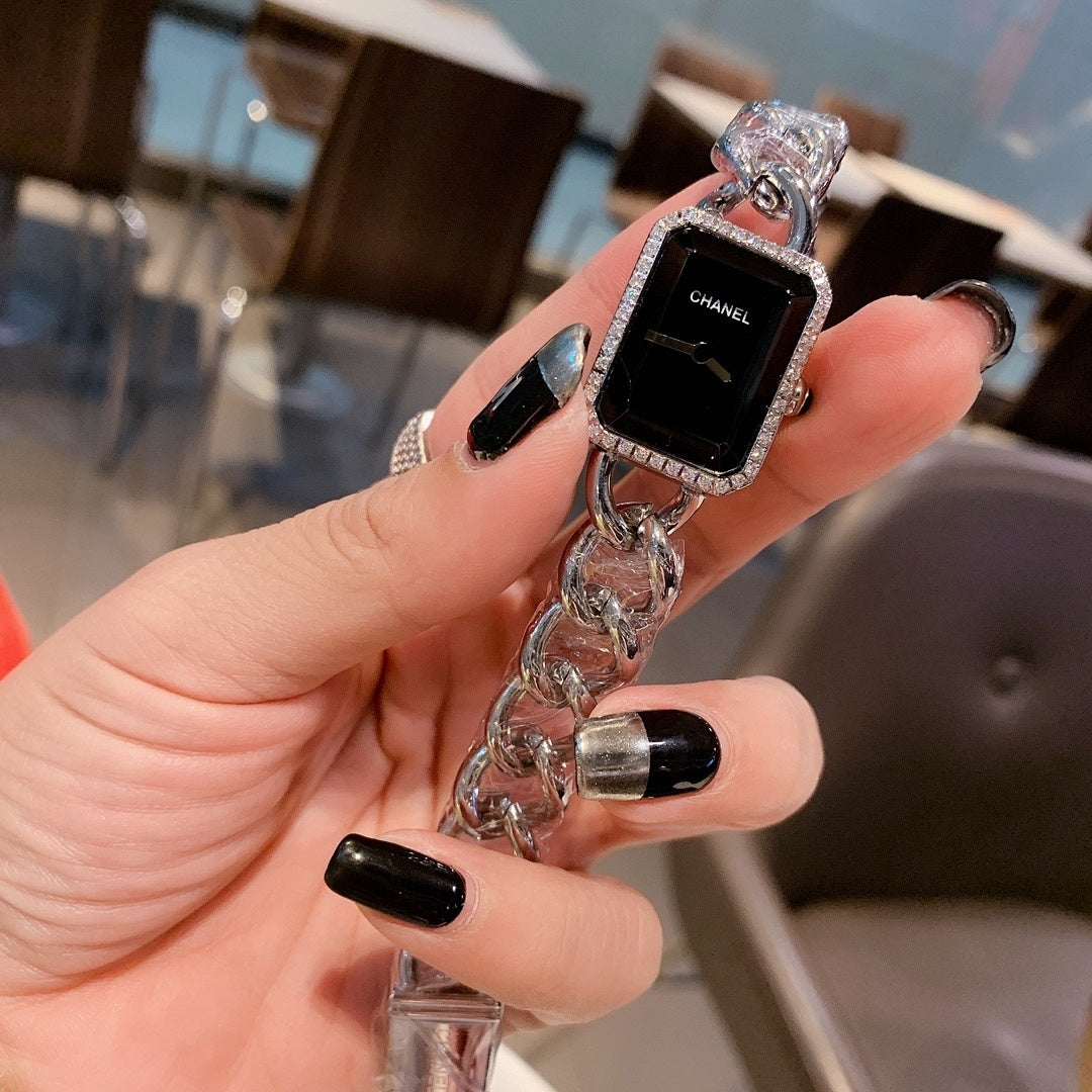 Rectangular Chanel wristwatch with black dial and silver chain bracelet