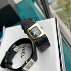 Chanel wristwatch with black leather strap and gold-tone square case, black dial view