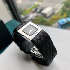 Chanel wristwatch with black leather strap and silver-tone square case, light dial