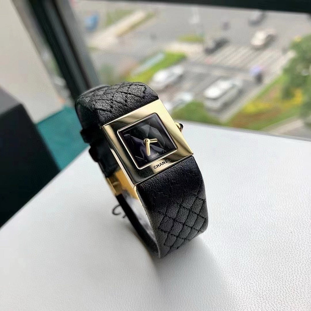 Chanel wristwatch with black leather strap and gold-tone square case, dark dial