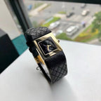Chanel wristwatch with black leather strap and gold-tone square case, dark dial