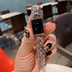 Silver-toned chain-link Chanel watch with black rectangular dial and crown detail.