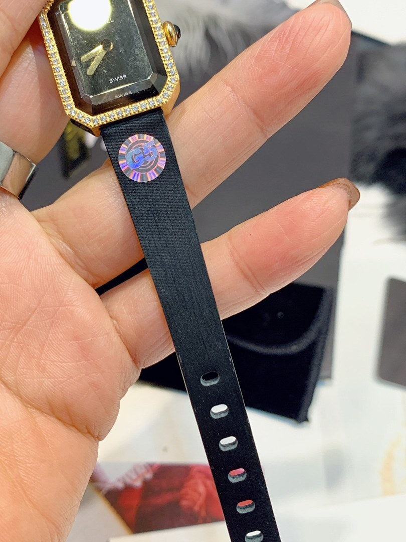 Black leather watch strap with buttonholes and stitched edge, gold-tone case