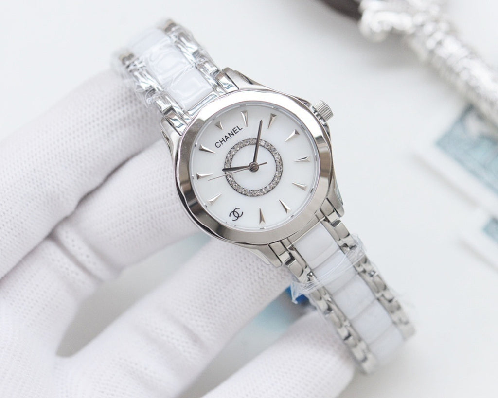 Chanel wristwatch with silver case, white dial, and light-colored metal bracelet