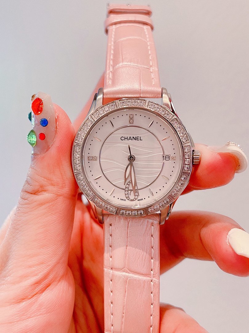 Chanel wrist watch with pink leather strap, jeweled bezel, white dial
