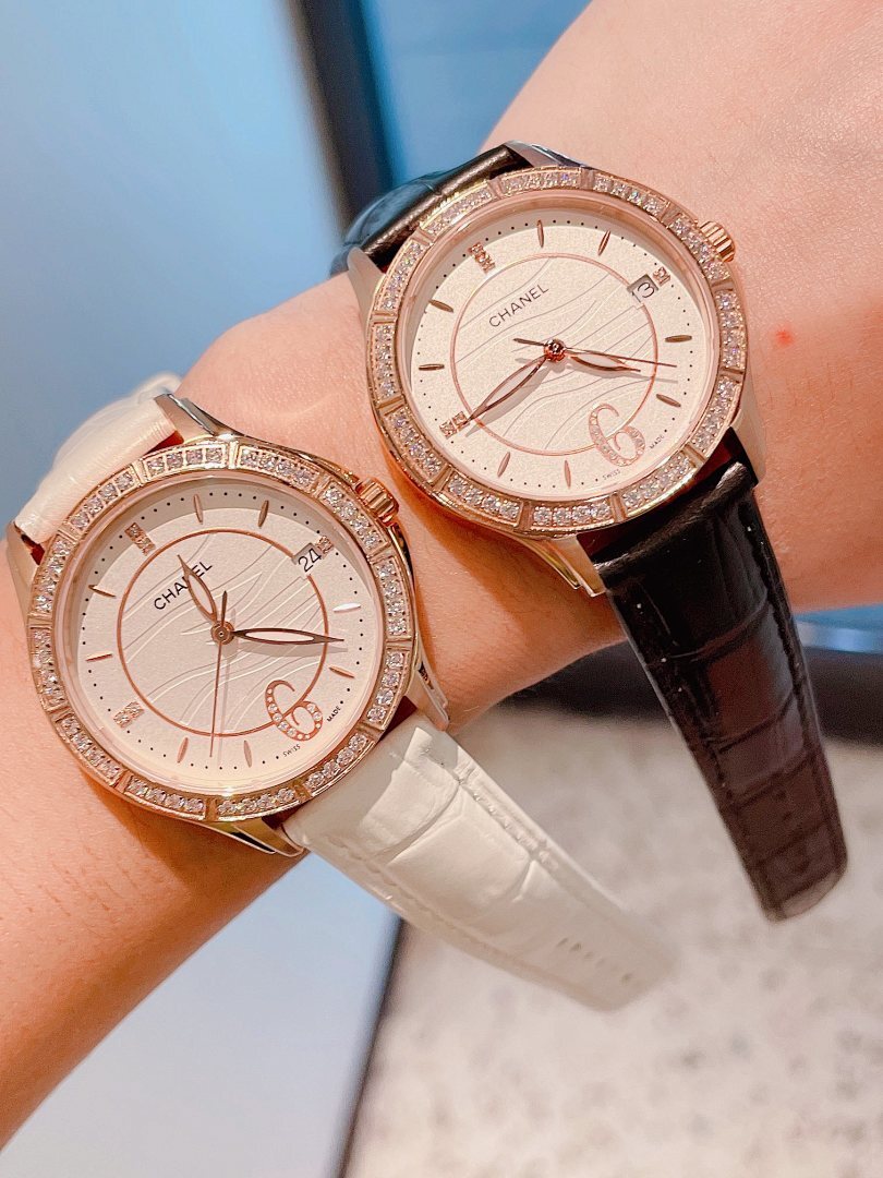 Luxury wristwatch with beaded diamond bezel, white dial, and black leather strap