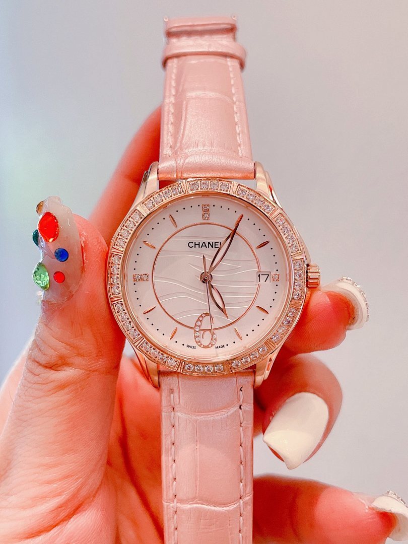 Chanel wrist watch with pink leather strap, rose-gold case, and jeweled bezel
