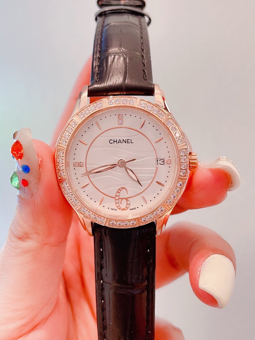 Chanel wrist watch with dark brown leather strap, rose-gold case, and jeweled bezel