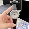 Chanel round wristwatch with black leather strap and silver-tone rhinestone bezel