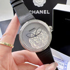 Chanel round wristwatch close-up of silver floral dial and black leather strap