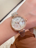 Chanel watch on wrist with rose-gold tone case and metal link bracelet, decorative dial