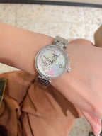 Chanel watch with silver-tone case, sparkling bezel, and silver metal link bracelet