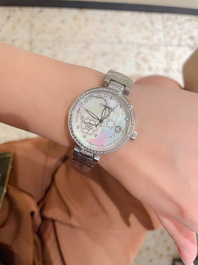 Chanel watch with silver-tone case, sparkling bezel, and silver metal link bracelet