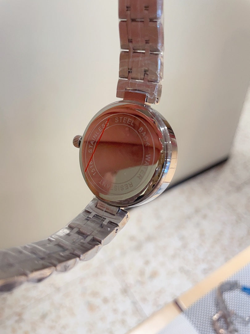 Chanel watch rear view with silver-tone metal strap and round case, crown at side
