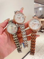 Set of three Chanel watches with silver and rose-gold tones and metal link bracelets