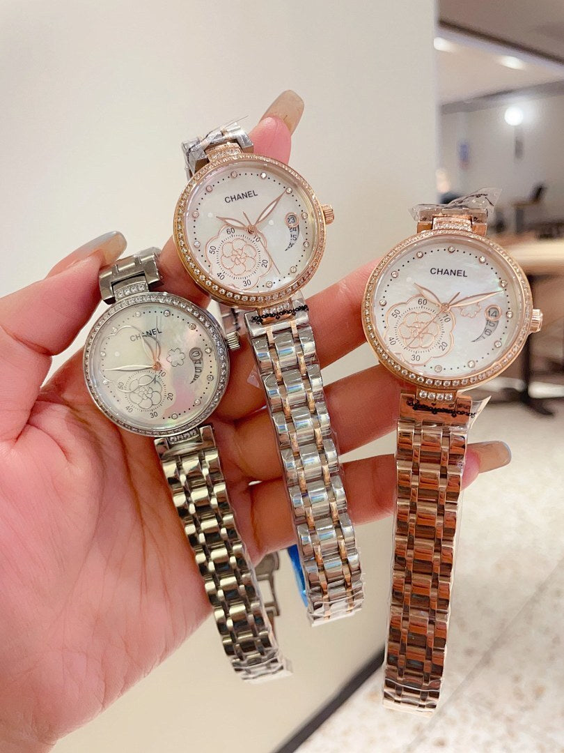 Set of three Chanel watches with silver and rose-gold tones and metal link bracelets