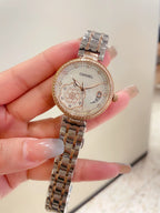 Chanel watch with rose-gold tone case and bezel, ornate dial, and rose-gold metal link bracelet