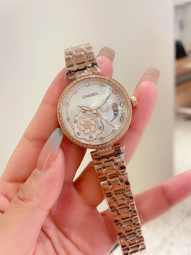 Chanel watch with rose-gold tone case, rhinestone bezel, and rose-gold metal link bracelet