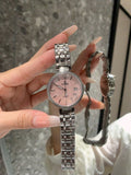 Chanel watch with silver bracelet and pink dial, round face