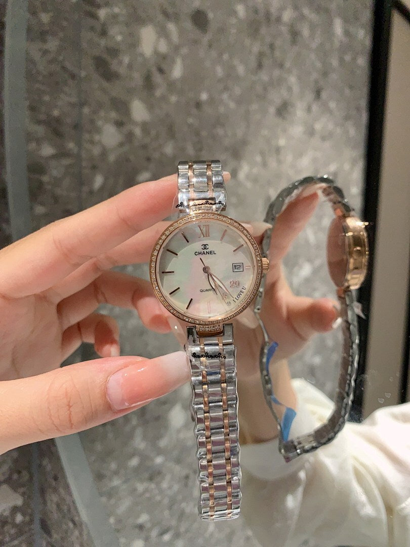 Chanel watch with white dial and silver bracelet, round bezel