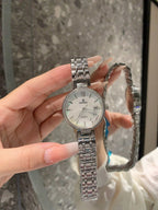 Chanel watch with pale dial and silver bracelet, round face close-up