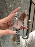 Chanel watch with silver bracelet and pink dial, metal bezel and hands