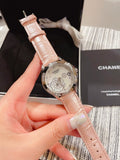 Chanel watch with pale pink leather strap and silver floral dial