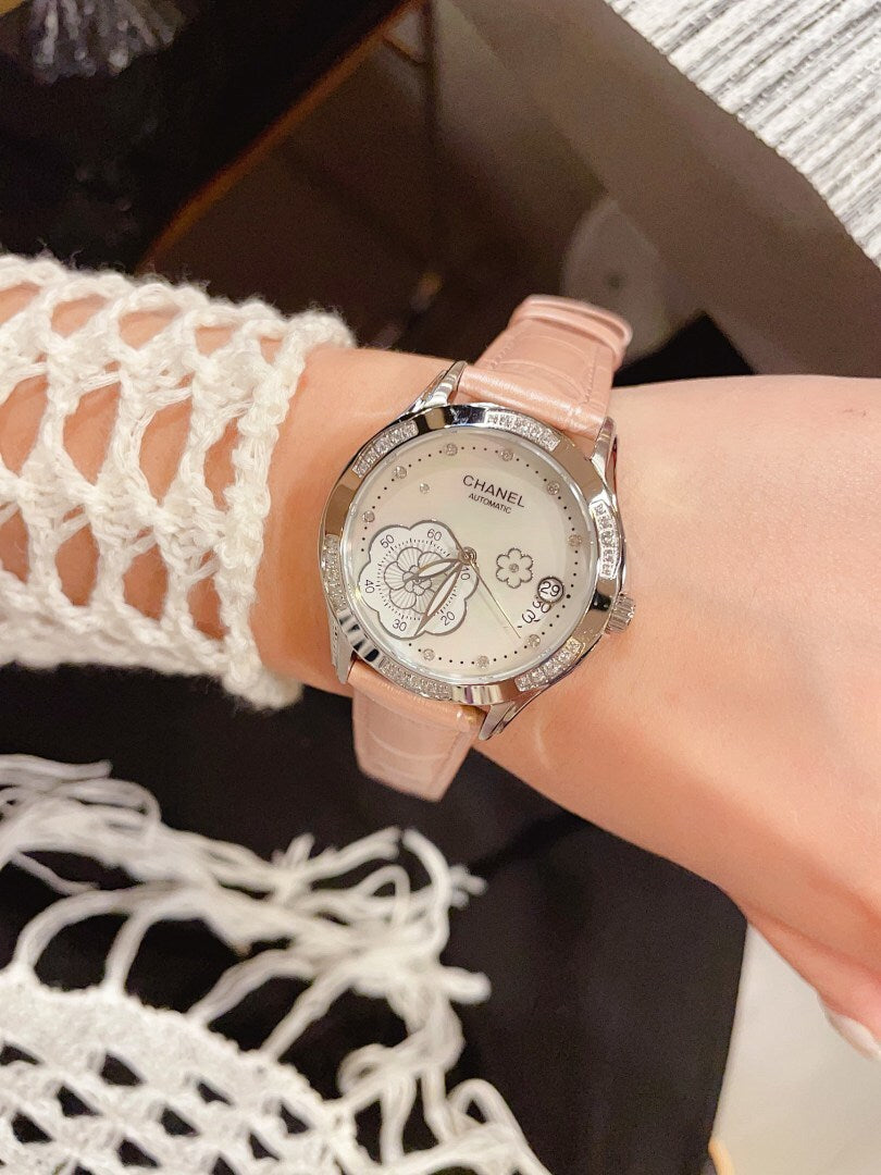 Chanel watch with pale pink leather strap, silver floral dial