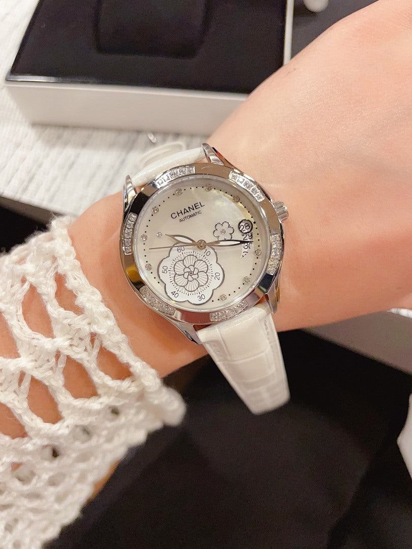 Chanel watch with white leather strap and silver floral dial