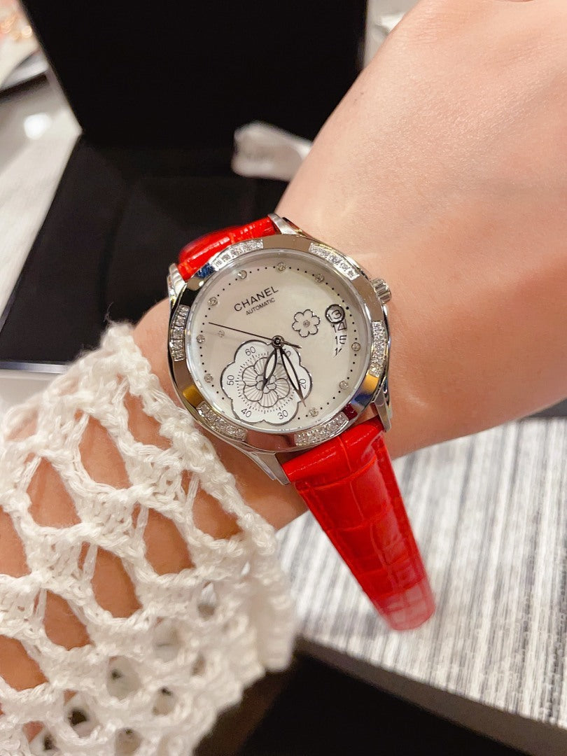 Chanel watch with red leather strap and silver floral butterfly dial