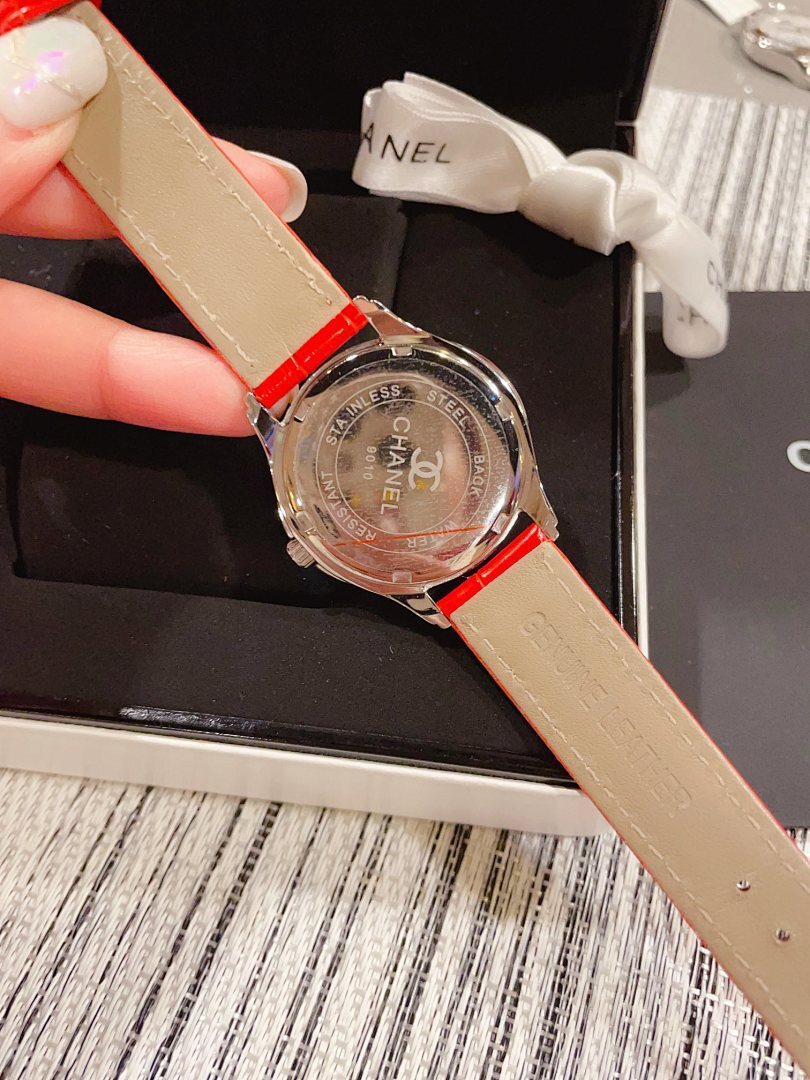 Chanel watch with beige leather strap, red caseback detail