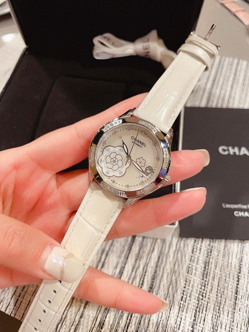 Chanel watch with white leather strap and silver floral dial