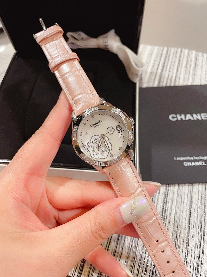 Chanel watch with pale pink leather strap and silver floral dial