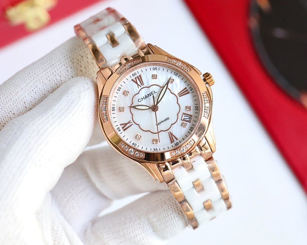 Rose gold Chanel watch with white dial, clover motif, Roman numerals, metal bracelet.