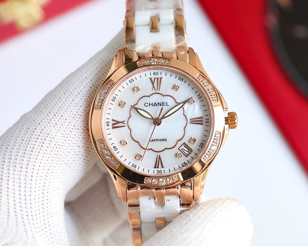 Rose gold Chanel watch front view with white dial, clover motif, Roman numerals, jeweled bezel.