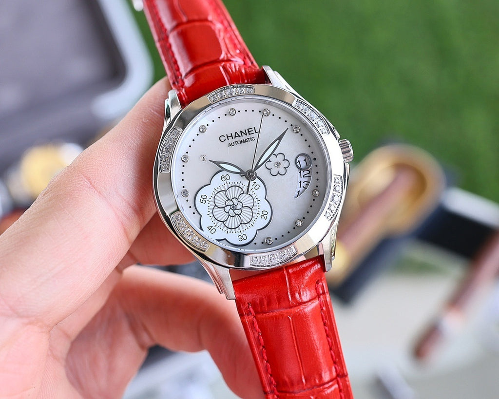 Analog watch with red leather strap, silver case, white dial and flower motif