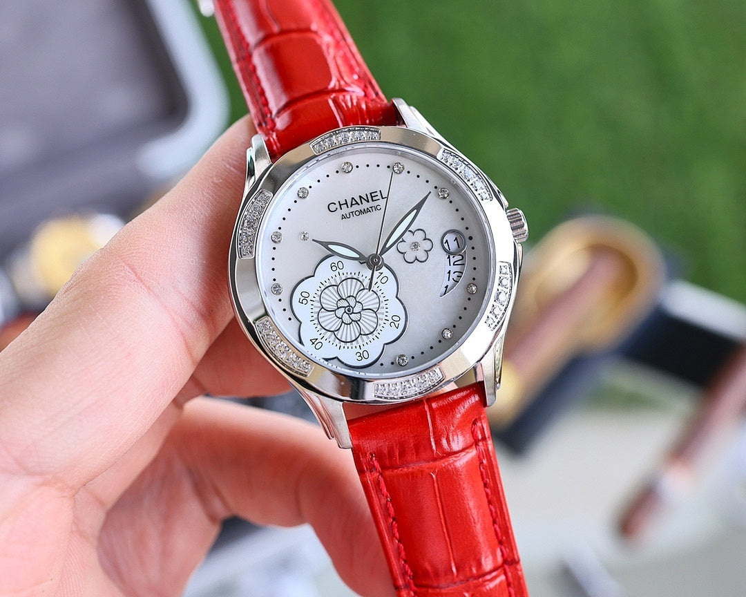 Analog watch with red leather strap, silver case, white dial and flower motif