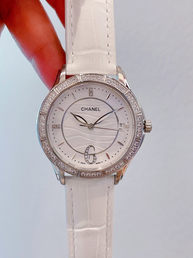 Wristwatch with white dial, crystal-look bezel, and white leather strap
