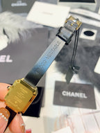 Chanel watch with gold-tone case back and buckle, dark blue leather strap
