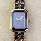 Gold-tone octagonal watch with navy blue strap and light dial, Chanel logo and hands