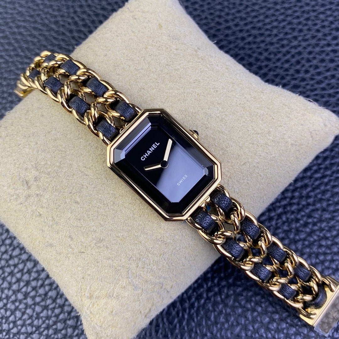 Gold-tone rectangular watch with navy blue chain bracelet and dark square dial, Chanel
