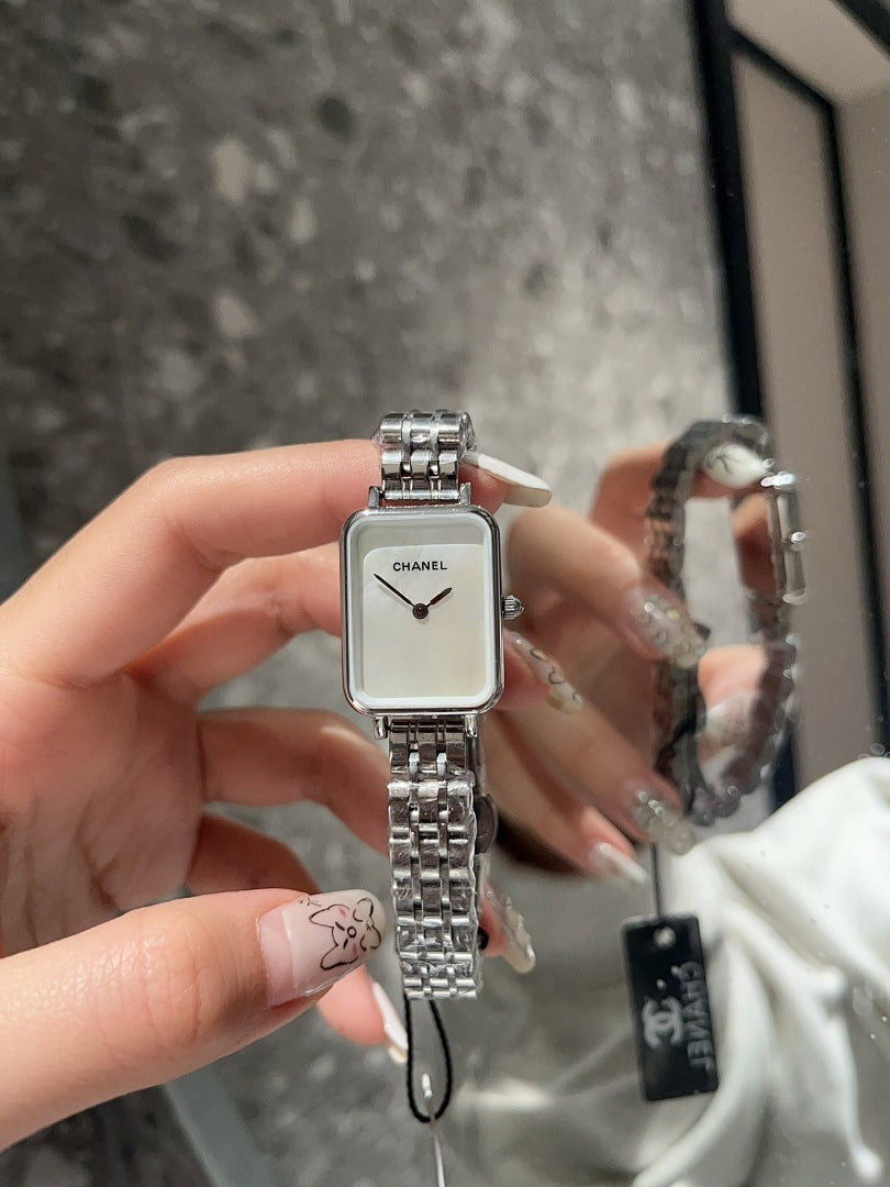 Rectangular wristwatch with silver-tone metal bracelet and white dial with black hands
