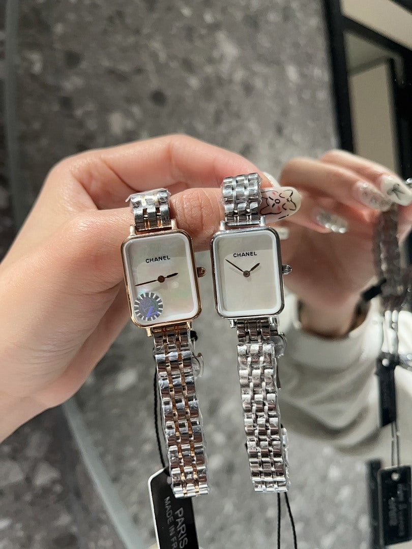 Two rectangular CHANEL wristwatches with silver-tone link bracelets and white dials