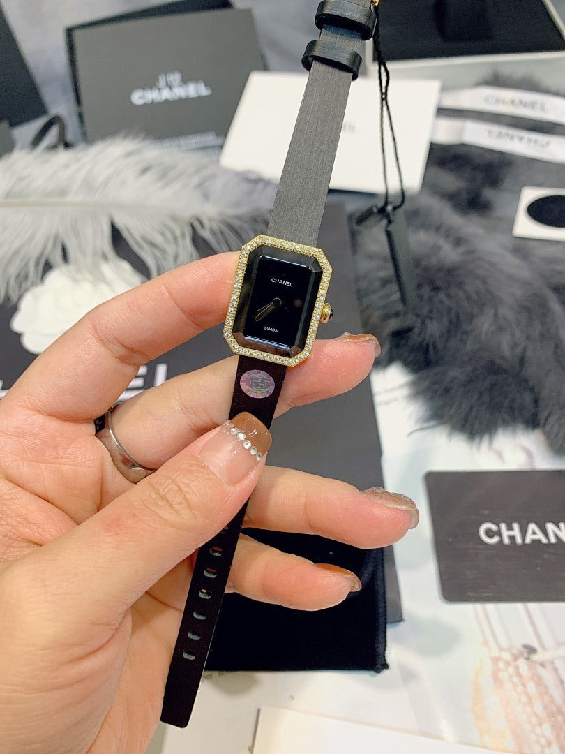 Chanel rectangular-dial watch with dark face and black strap