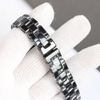 Chanel automatic watch bracelet close-up with glossy steel links and clasp