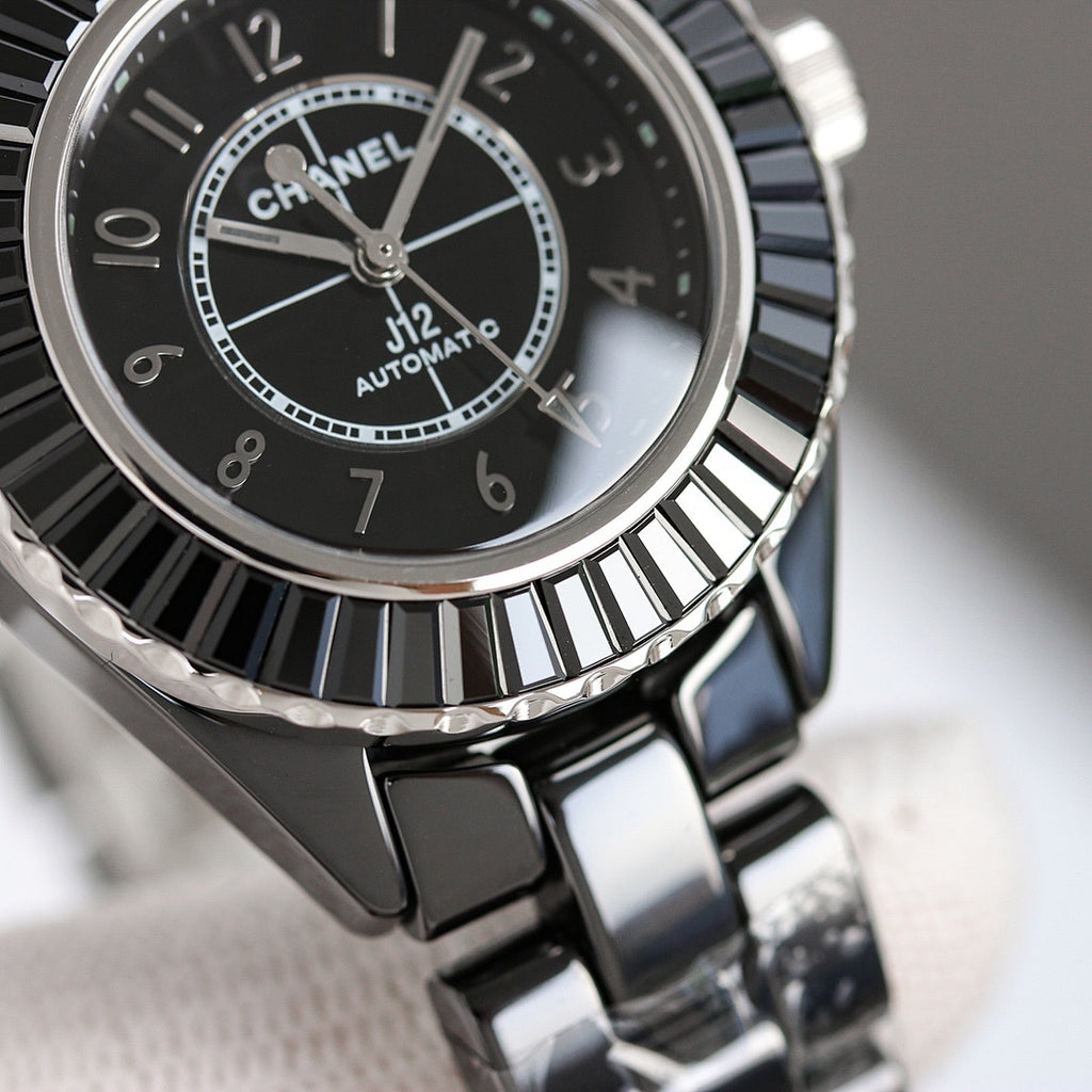 Chanel automatic wristwatch close-up of black dial, silver hands and bezel