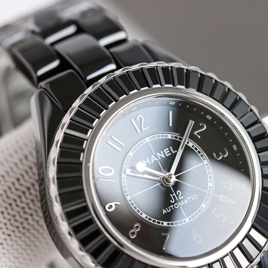 Chanel automatic wristwatch close-up, light dial with silver markers and black bezel