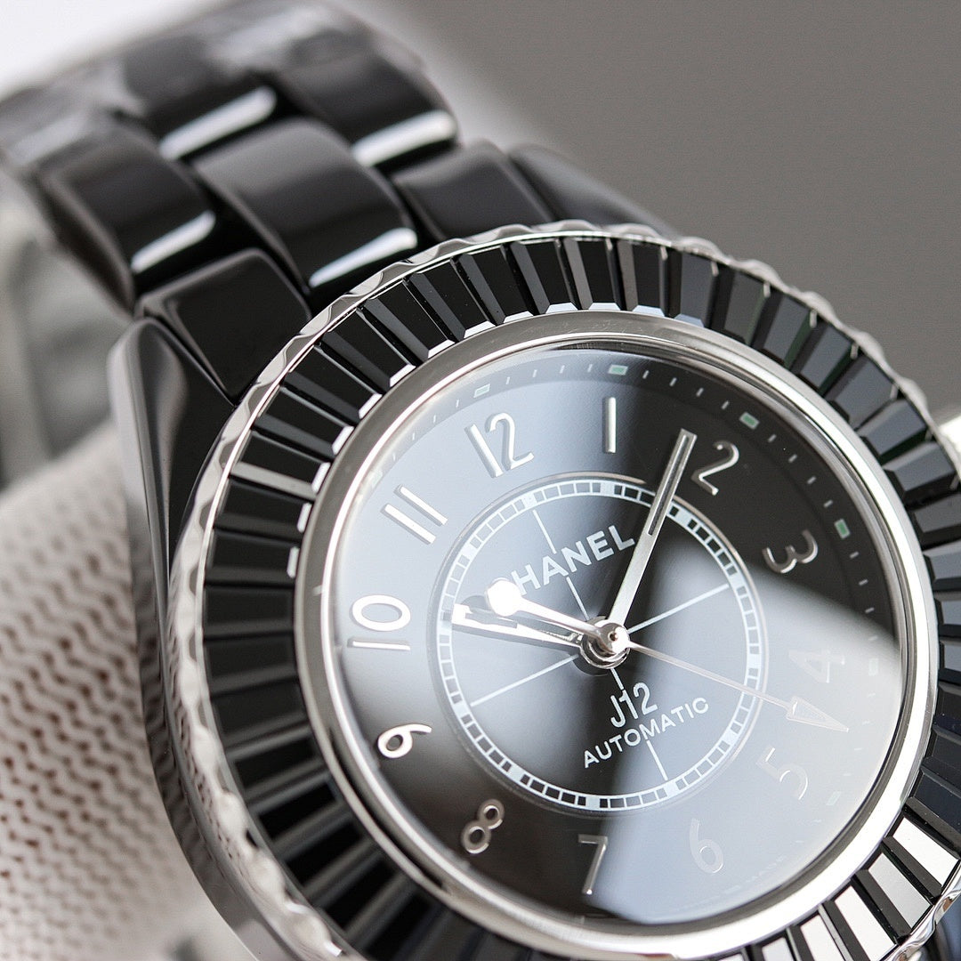 Chanel automatic wristwatch close-up, light dial with silver markers and black bezel