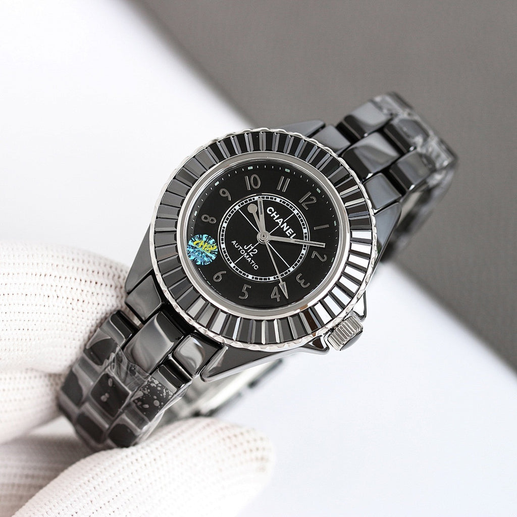 Chanel automatic wristwatch angled on glove, black dial with patterned bezel